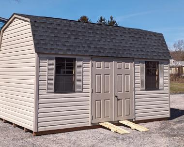 10x16 Dutch Barn Storage Shed. In Warm Sandalwood Vinyl Siding with clay trim, doors, and shutters